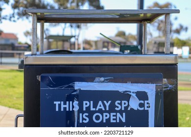 Hoppers Crossing, Vic Australia - September 19 2022: Rubbish Bin With Signage That Play Space Is Open After Covid Lockdowns In Suburban Parkland In Melbourne