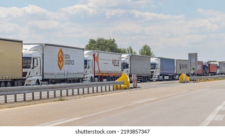 Horgos Roszke, Hungary - August 01, 2022: Long Queue Of Lorry Cargo Trucks Stuck At EU Border Entrance.