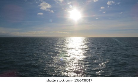 Horizon Line Featuring Sun Reflecting On The Surface Of The Ocean