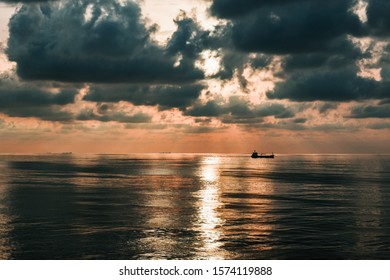 Horizon Over Water With Moody Clouds And A Sailing Ship