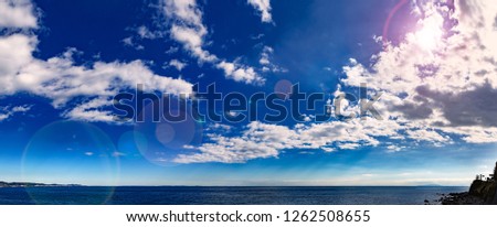 wooden platform with blue posts with ropes and orange lifebuoys on the background of the sea and sky with clouds Egypt Dahab South Sinai