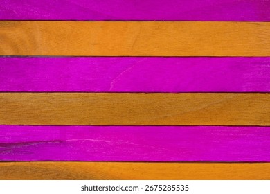 Horizontal alternating pattern of pink and orange painted wooden planks, close-up surface texture.