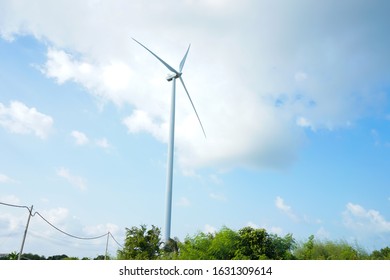 Horizontal Axis Wind Turbine On Sky White Clouds.