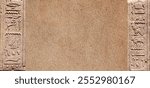 Horizontal background with ancient Egyptian hieroglyphs on stone wall, Egypt, Africa. Backdrop with sandstone carving with hieroglyph. Mock up template. Copy space for text