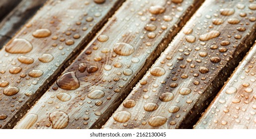 horizontal background of lacquered burnt wood texture with shiny water drops from the rain, wet wooden planks - Shutterstock ID 2162130045