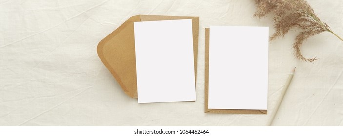 Horizontal banner with 2 blank cards mockup and brown envelopes for design or photo presentation, neutral colors, bohemian style.  
