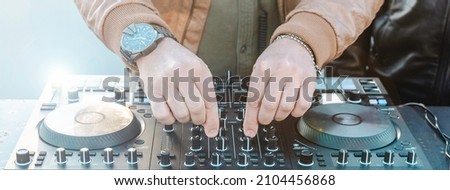 Horizontal banner or header with disc jockey hands playing music for tourist people at beach party outdoor - Live event, music concept - Bright filter with focus on hands Сток-фото © 
