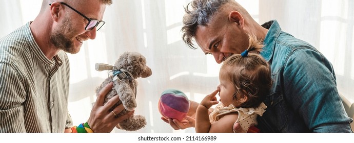 Horizontal Banner Or Header With Male Gay Couple With Adopted Baby Girl At Home - Two Fathers Playing With Their Daughter - Lgbtq+ Family At Home - Diversity Concept And LGBTQ Family Relationship