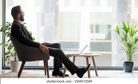 Horizontal banner middle eastern ethnicity businessman sit on armchair resting in modern room looks out window thinking about prosperous his own company plan future projects, business vision concept - Shutterstock ID 1504573349
