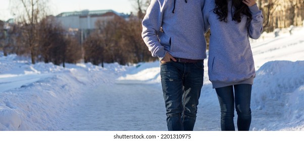 horizontal banner with a stylish and fashionable couple in fashion gray  hoodie outside in winter.young couple in style wear.fashion concept. couple in oversize hoodie at the street. - Shutterstock ID 2201310975