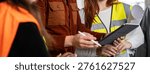 Horizontal banner or template with engineer supervisor at construction site with his female work team setting guidelines in building site office - Teamwork concept