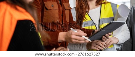 Horizontal banner or template with engineer supervisor at construction site with his female work team setting guidelines in building site office - Teamwork concept