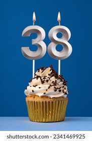Horizontal birthday card with cake - Lit candle number 38 on blue background