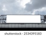 Horizontal blank billboard on metal truss structure on cloudy sky background. Mock-up.