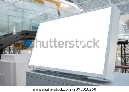 Horizontal blank digital interactive white display of electronic kiosk at exhibition or museum with futuristic scifi interior: close up. White screen, mock up, future, copyspace, technology concept
