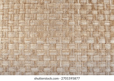 Horizontal capture. Surface of organic material like jute or sisal, check pattern. Sharp focus on the material, ideal as a high-resolution background for sustainability or interior design themes