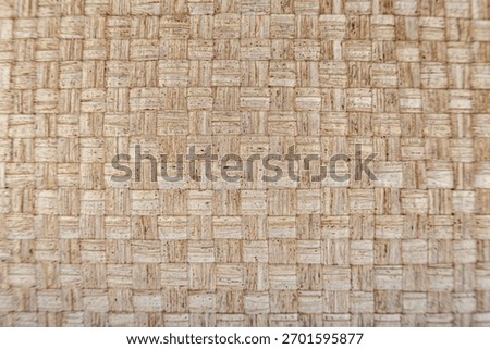 Horizontal capture. Surface of organic material like jute or sisal, check pattern. Sharp focus on the material, ideal as a high-resolution background for sustainability or interior design themes