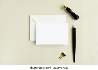 Horizontal card mockup for lettering, greeting card, notecard, invitation design presentation, white envelope, wax seal stamp and calligraphy pen.