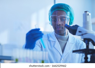 Horizontal Chest Up Portrait Of Young Male Medical Scientist Wearing Protective Mask Doing Laboratory Tests, Copy Space