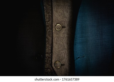 A Horizontal Close Up Shot Of A Male Blue Suit Over A Gold Ornamented Vest