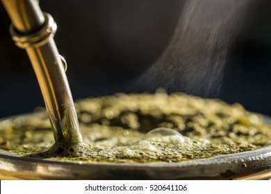 Horizontal Close-Up Of Hot Traditional South American Caffeine-Rich Infused Drink Mate, In Traditional Calabash Gourd. Hot Steaming Yerba Mate Tea, South American Tradition, National Drink Of Uruguay.