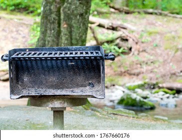 Horizontal Close-up Shot Of A Well Used Public Area Barbecue Grill Straight On. 