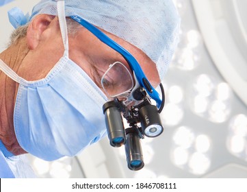 A Horizontal Closeup Of A Veteran Surgeon Wearing An Advanced Surgical Loupe During An Operation