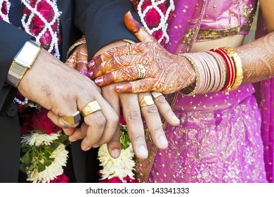 Horizontal Color Capture Taken At A Hindu Wedding In Surat India. Photo Session After The Ceremony Of The Happy Hand Holding Couple Displaying Their Rings Of Matrimony And The Bride Lays Her Claim