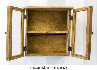 Horizontal Composition Of Rustic Empty Wood Display Cabinet Mounted On Wall With Its Doors Open. 