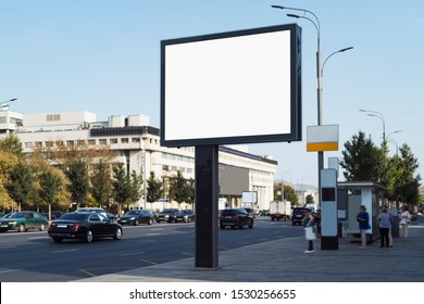 Horizontal Digital Banner Near Bus Stop On Busy Road In City Center. Drivers, Passengers And Pedestrians Looking At Commercial Ads On Billboard With Big Screen. Highway With Several Lanes, Street Lamp