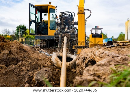 
Horizontal directional drilling technology closeup. Drilling machine work process. Trenchless laying of communications, pipes and water pipes