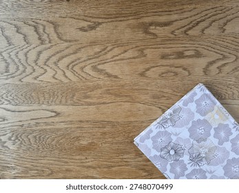 
Horizontal Flat Lay Of Floral Patterned Hardcover Notebook On Wooden Surface With Copy Space.
