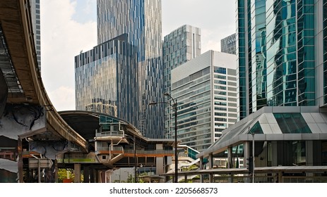 horizontal framing of Kuala Lumpur's city scape : aerial train and roads crossing at the feet of the skyscrapers under the midday light. - Shutterstock ID 2205668573
