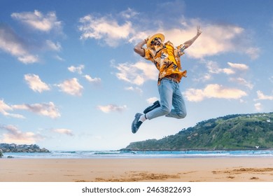 Horizontal full length photo of an african young man jumping celebrating holidays on the beach - Powered by Shutterstock