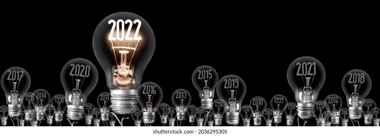 Horizontal group of shining light bulb with fiber in a shape of New Year 2022 and dimmed light bulbs with years passed isolated on black background. - Shutterstock ID 2036295305
