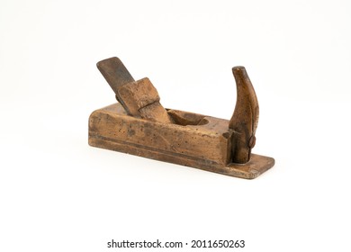 Horizontal high angle angle studio shot of small vintage wood planer isolated on white background. Old carpenter tool with wood worm holes in it. Carpentry concept.