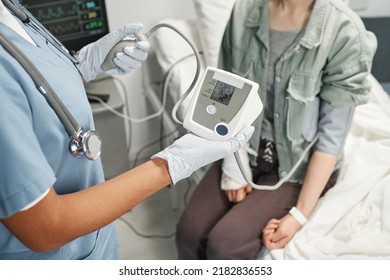 Horizontal High Angle View Shot Of Unrecognizable Doctor Measuring Blood Pressure Of Woman In Emergency Room