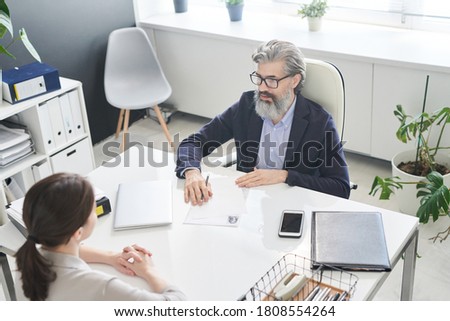 Horizontal high angle view shot of unrecognizable young woman having job interview in modern company office