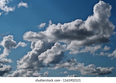 Horizontal image of dramatic clouds with bright blue sky in background