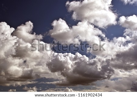 Horizontal image of dramatic clouds with bright blue sky in background