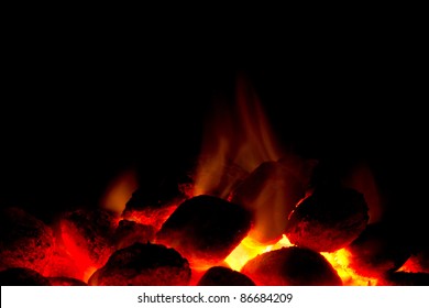 Horizontal image of hot charcoal fire ready for barbecue with black copy-space