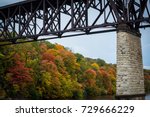 Horizontal image of Short Line Bridge. Milwaukee Road Mississippi River Crossing. Minneapolis, MN USA. Fall colors in green, orange and red 