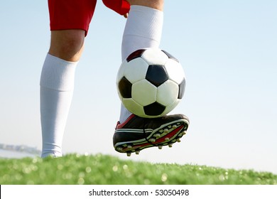 Horizontal image of soccer ball being kicked by footballer