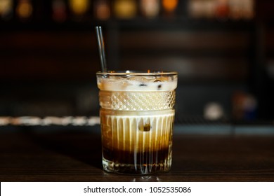 A Horizontal Image Of A White Russian Cocktail In Rocks Glass In A Bar.