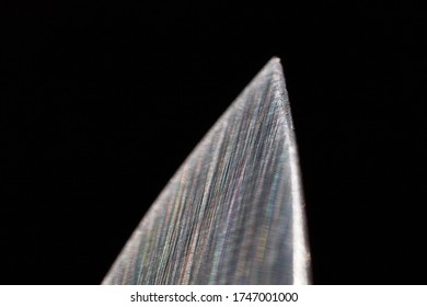 Horizontal Macro Detail Of Tip Of Sharp Stainless Steel Chef Knife Agains Dark Background