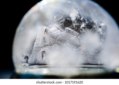 horizontal macro image of freezing soap bubble.  Shallow depth of field with contrasting crystals forming in the sub zero weather. 