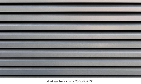 Horizontal metal panel texture background. Close-up view of a horizontal metal panel texture with evenly spaced parallel lines creating a uniform pattern.