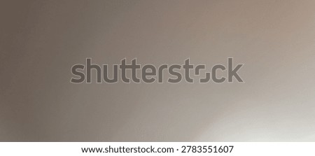 Horizontal minimal backdrop of a flat solid grey painted wall with smooth lighting falloff across the surface
