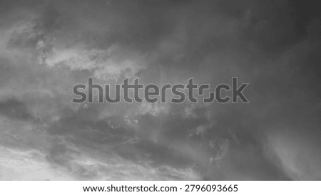 A horizontal monochrome perspective captures dense textures of churning dark storm clouds filling the overcast evening sky. The deep atmospheric layers create a moody natural contrast, offering a beautiful minimalist presentation background layout template with massive open copy space for text overlay or creative digital design projects.