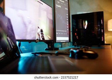 Horizontal No People Shot Of Laptop, Computer And Video Game Console Controller On Table In Room Belonging To Gamer And Cryptocurrency Trader